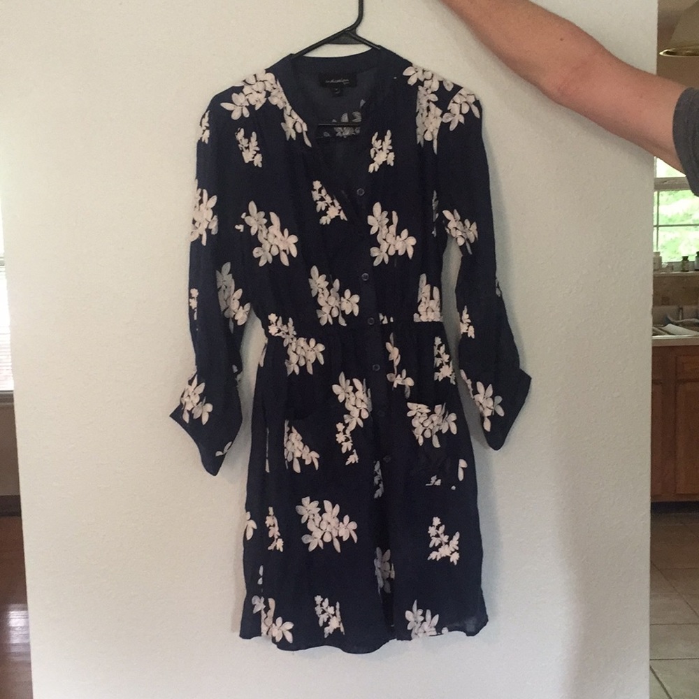 Cute navy dress with white floral stitching.